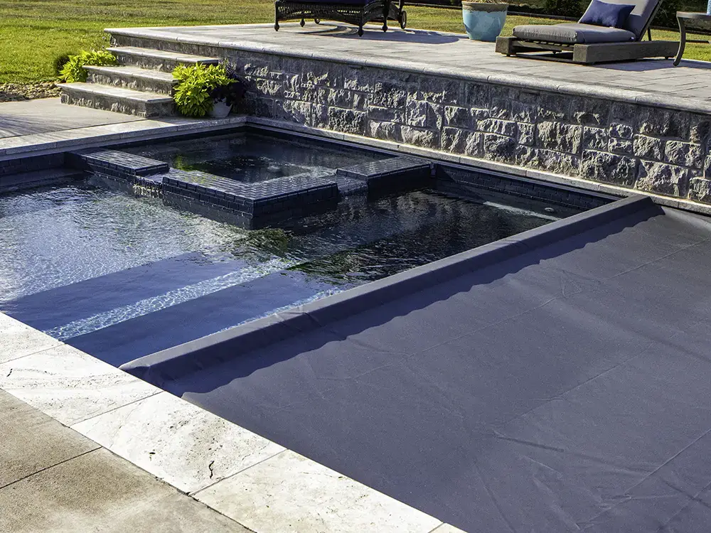Sleek Coverstar automatic pool cover closing over a modern geometric pool